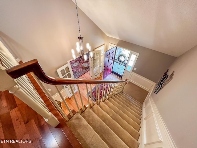 12218 Torrey Pines Pt, Knoxville, TN 37934 - stairs with wood finished floors, a chandelier, and vaulted ceiling