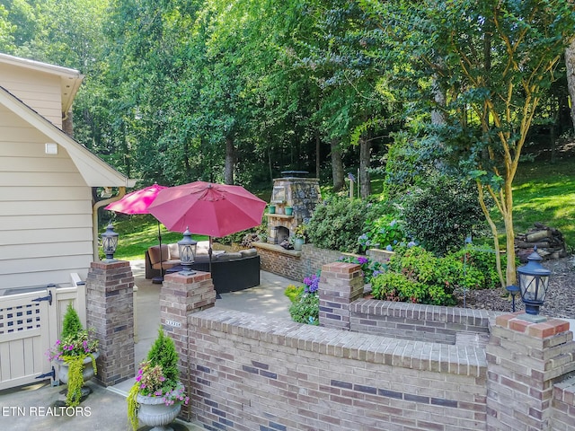12218 Torrey Pines Pt, Knoxville, TN 37934 - view of patio / terrace with an outdoor living space with a fireplace