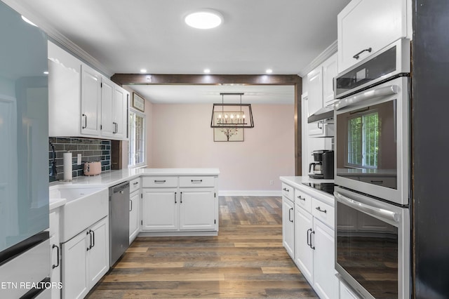 101 Concord Rd, Oak Ridge, TN 37830 - kitchen featuring appliances with stainless steel finishes, a peninsula, wood finished floors, white cabinets, and recessed lighting