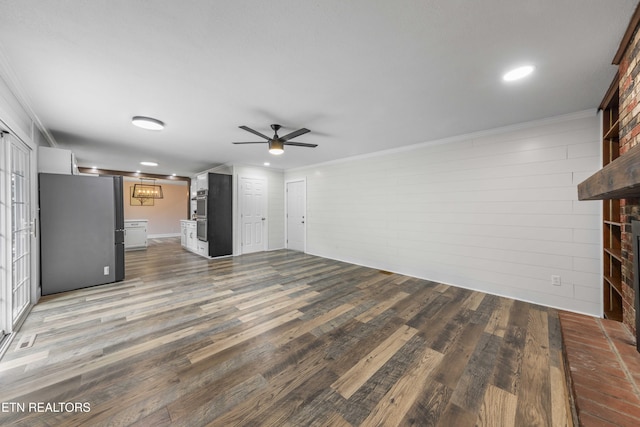 101 Concord Rd, Oak Ridge, TN 37830 - unfurnished living room featuring a ceiling fan, ornamental molding, wood finished floors, recessed lighting, and a brick fireplace