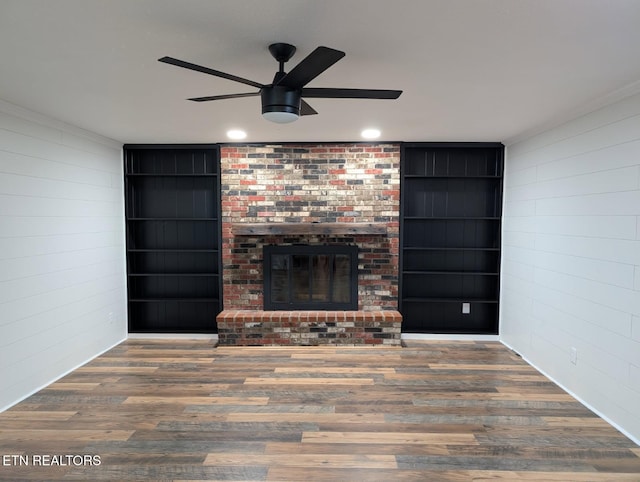 101 Concord Rd, Oak Ridge, TN 37830 - unfurnished living room with a ceiling fan, built in shelves, wood finished floors, a brick fireplace, and wood walls