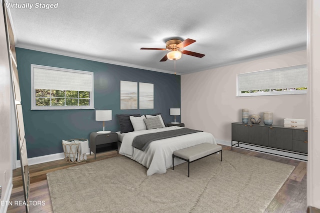 101 Concord Rd, Oak Ridge, TN 37830 - bedroom with wood finished floors, crown molding, a textured ceiling, a baseboard heating unit, and ceiling fan
