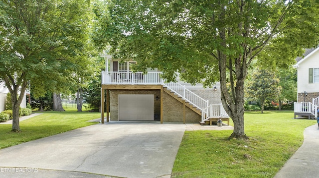 814 Plantation Dr, Pigeon Forge, TN 37863 - view of front of home with stairway, concrete driveway, brick siding, a front lawn, and a porch