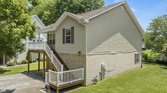 814 Plantation Dr, Pigeon Forge, TN 37863 - view of side of home with a lawn, a shingled roof, stairway, and stucco siding