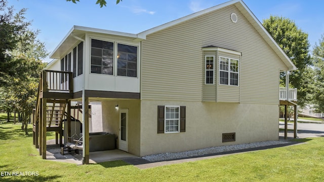 814 Plantation Dr, Pigeon Forge, TN 37863 - view of property exterior with stairway, a lawn, a patio area, stucco siding, and a sunroom