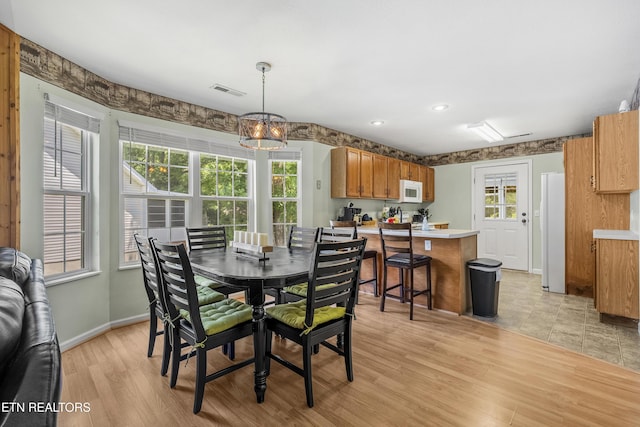 814 Plantation Dr, Pigeon Forge, TN 37863 - dining area featuring a chandelier and light wood-style flooring