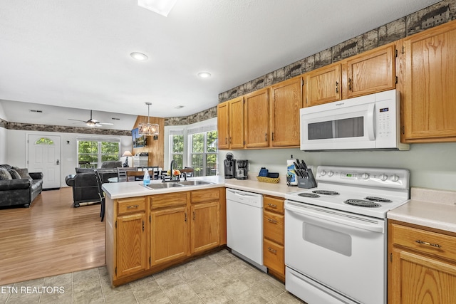 814 Plantation Dr, Pigeon Forge, TN 37863 - kitchen featuring white appliances, a peninsula, open floor plan, light countertops, and ceiling fan
