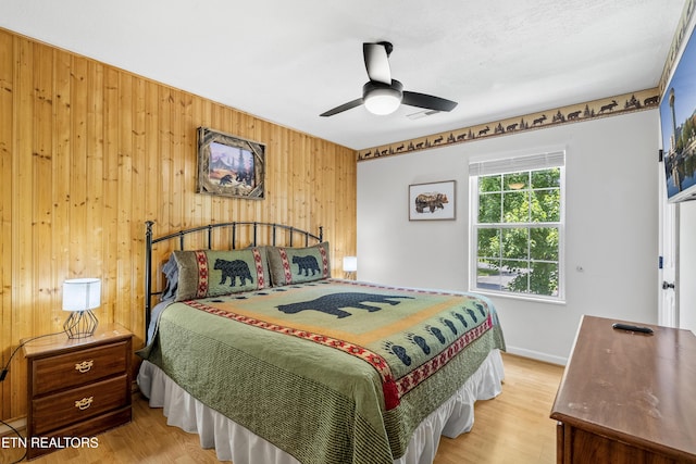 814 Plantation Dr, Pigeon Forge, TN 37863 - bedroom with wooden walls, wood finished floors, and ceiling fan