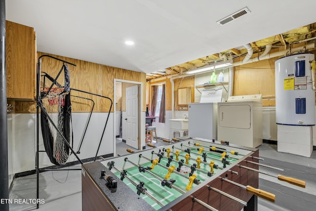 814 Plantation Dr, Pigeon Forge, TN 37863 - game room featuring separate washer and dryer, water heater, finished concrete floors, and wooden walls