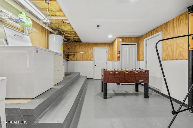 814 Plantation Dr, Pigeon Forge, TN 37863 - playroom featuring washer and dryer, finished concrete flooring, and water heater