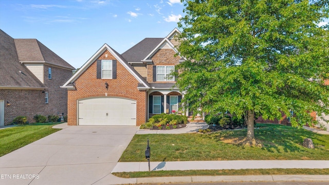 1213 Whisper Trace Ln, Knoxville, TN 37919 - traditional-style home featuring driveway, a front lawn, brick siding, and an attached garage