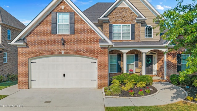 1213 Whisper Trace Ln, Knoxville, TN 37919 - traditional-style home featuring brick siding, driveway, a porch, and a garage