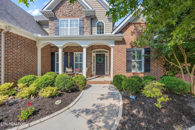 1213 Whisper Trace Ln, Knoxville, TN 37919 - property entrance with a porch, brick siding, and stone siding
