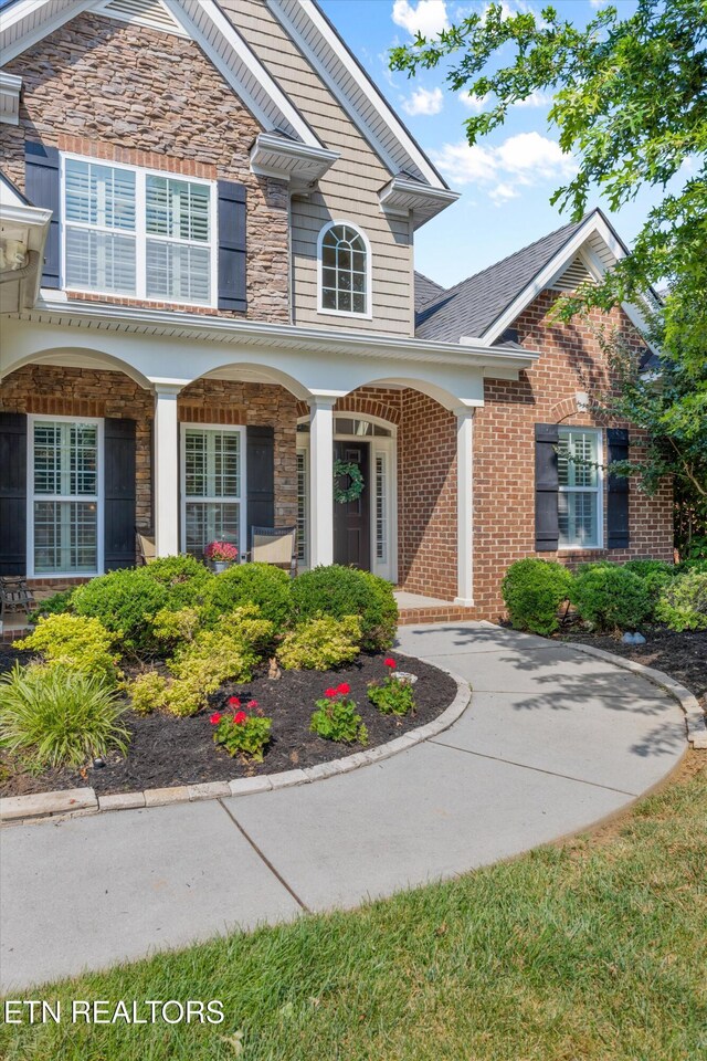 1213 Whisper Trace Ln, Knoxville, TN 37919 - entrance to property featuring stone siding, brick siding, and a porch
