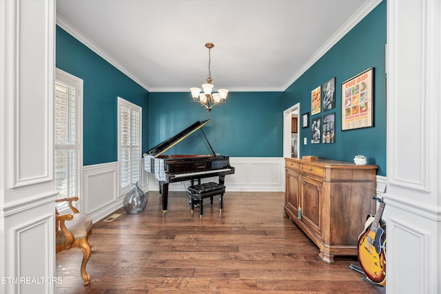 1213 Whisper Trace Ln, Knoxville, TN 37919 - living area featuring a chandelier, crown molding, wood finished floors, a decorative wall, and wainscoting