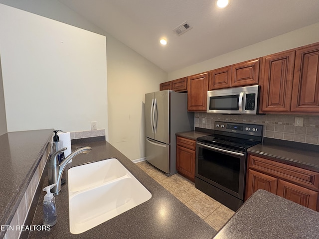 8106 Spice Tree Way, Knoxville, TN 37931 - kitchen with appliances with stainless steel finishes, dark countertops, vaulted ceiling, tasteful backsplash, and recessed lighting