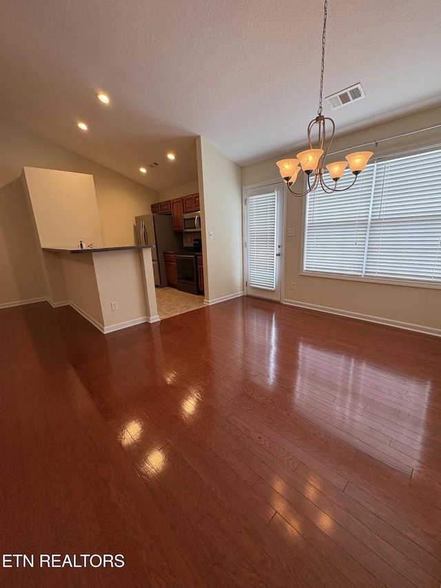8106 Spice Tree Way, Knoxville, TN 37931 - unfurnished living room featuring a chandelier, dark wood-style floors, a textured ceiling, recessed lighting, and vaulted ceiling