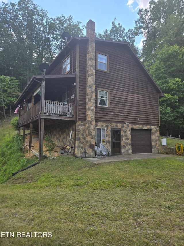 199 Pear Tree Way, Del Rio, TN 37727 - rear view of house featuring stone siding, a yard, and a garage