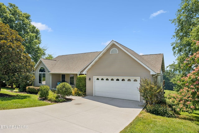 3930 Settlers Trl, Kodak, TN 37764 - view of front of home with concrete driveway, a garage, a front lawn, and roof with shingles