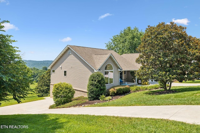 3930 Settlers Trl, Kodak, TN 37764 - view of property exterior featuring a yard, a shingled roof, and driveway