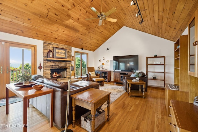 3930 Settlers Trl, Kodak, TN 37764 - living room with a fireplace, track lighting, light wood-type flooring, vaulted ceiling, and wooden ceiling