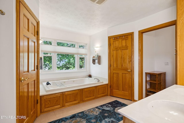 3930 Settlers Trl, Kodak, TN 37764 - full bathroom featuring tile patterned floors, a garden tub, double vanity, and a textured ceiling