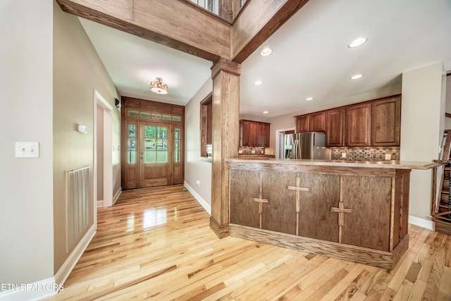 1328 E Millers Cove Rd, Walland, TN 37886 - kitchen with stainless steel fridge, light wood-style floors, a peninsula, backsplash, and recessed lighting