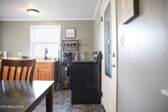1210 Frank Campbell Rd, Jamestown, TN 38556 - kitchen featuring crown molding, washer / clothes dryer, brown cabinetry, dark stone finish flooring, and light countertops