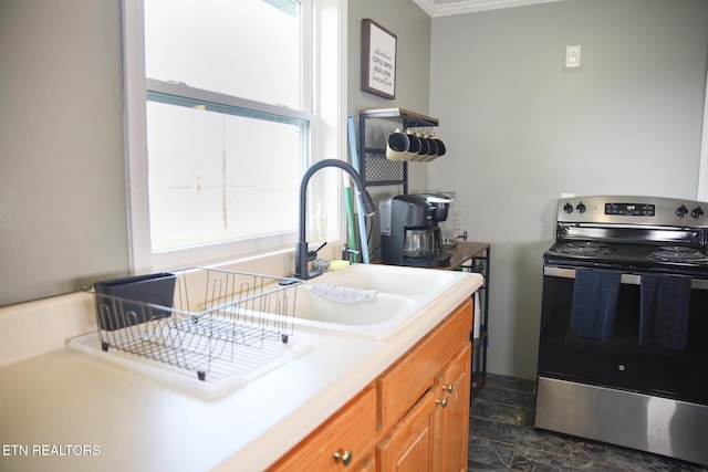 1210 Frank Campbell Rd, Jamestown, TN 38556 - kitchen featuring electric range, brown cabinets, light countertops, dark stone finish floors, and ornamental molding