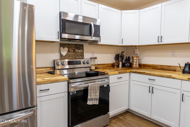 1210 Frank Campbell Rd, Jamestown, TN 38556 - kitchen with wooden counters, appliances with stainless steel finishes, white cabinetry, and light wood-style floors