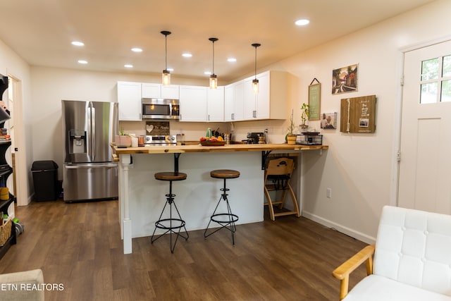 1210 Frank Campbell Rd, Jamestown, TN 38556 - kitchen featuring stainless steel appliances, butcher block countertops, dark wood-style floors, a peninsula, and recessed lighting