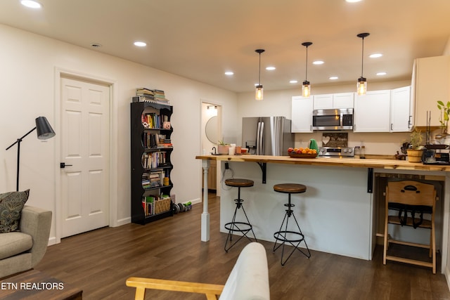 1210 Frank Campbell Rd, Jamestown, TN 38556 - kitchen featuring appliances with stainless steel finishes, wooden counters, dark wood-type flooring, a peninsula, and recessed lighting