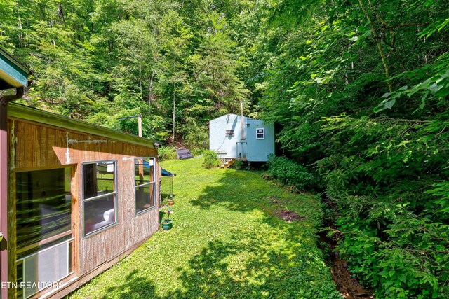 3255 Bear Mountain Ln, Sevierville, TN 37876 - view of green lawn featuring a forest view and an outbuilding