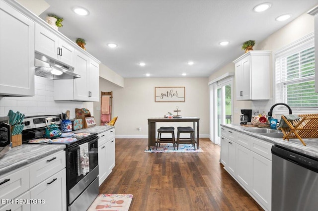 226 Hilldale Ln, Lafollette, TN 37766 - kitchen with stainless steel appliances, under cabinet range hood, backsplash, light countertops, and recessed lighting
