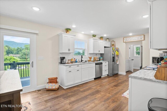 226 Hilldale Ln, Lafollette, TN 37766 - kitchen featuring stainless steel appliances, light countertops, white cabinetry, wood finished floors, and recessed lighting