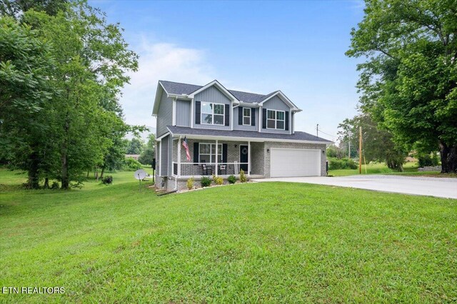 226 Hilldale Ln, Lafollette, TN 37766 - view of front facade with covered porch, driveway, a front lawn, and an attached garage