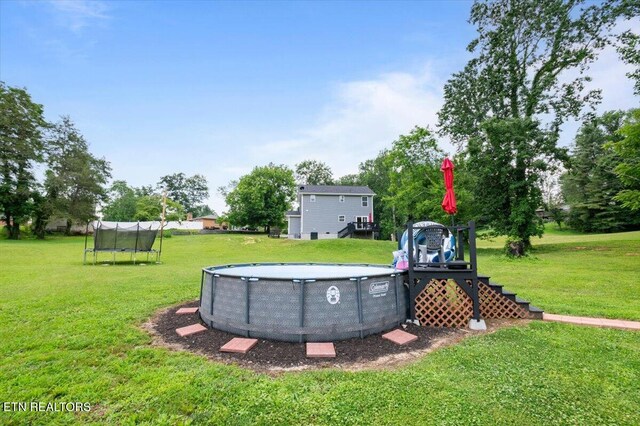 226 Hilldale Ln, Lafollette, TN 37766 - view of grassy yard featuring a trampoline and an outdoor pool