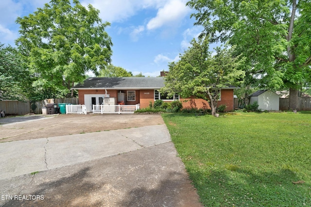 1415 Ebenezer Rd, Knoxville, TN 37922 - ranch-style house featuring brick siding, concrete driveway, and a storage unit