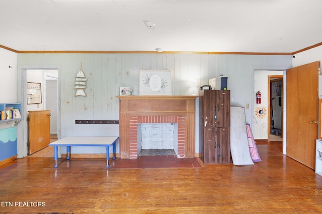 1415 Ebenezer Rd, Knoxville, TN 37922 - living room with ornamental molding, a brick fireplace, wood finished floors, and wood walls