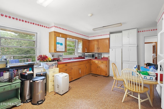 1415 Ebenezer Rd, Knoxville, TN 37922 - kitchen with stainless steel microwave and brown cabinets