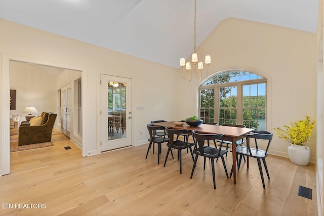 200 Stony Rock Ln, Jacksboro, TN 37757 - dining space featuring light wood-style flooring, french doors, high vaulted ceiling, and a chandelier
