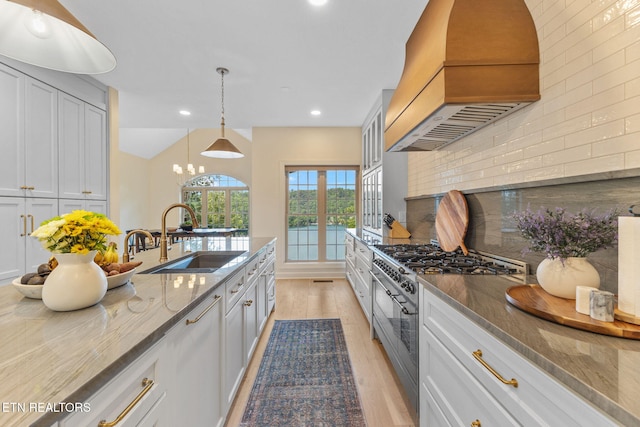 200 Stony Rock Ln, Jacksboro, TN 37757 - kitchen featuring stainless steel stove, premium range hood, stone counters, recessed lighting, and light wood-style flooring