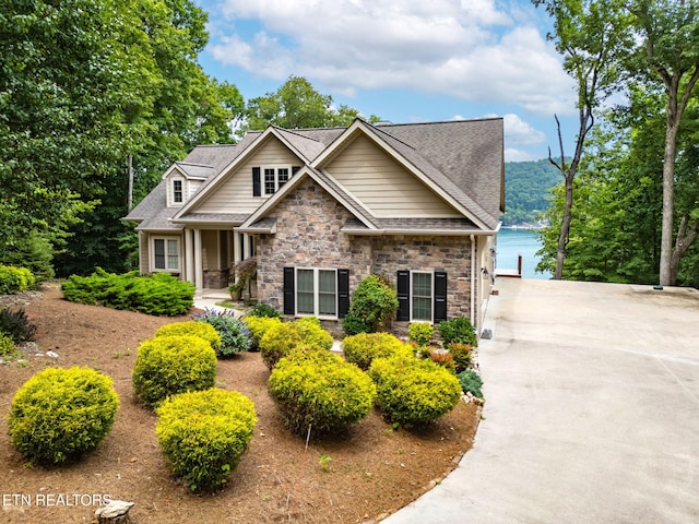 200 Stony Rock Ln, Jacksboro, TN 37757 - craftsman-style home featuring stone siding, roof with shingles, and driveway