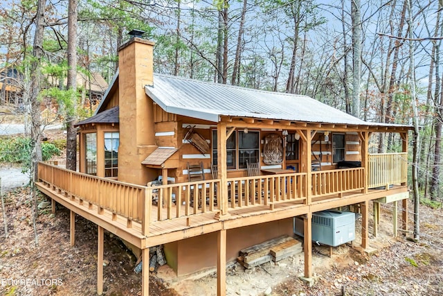 1505 Dawn Ln, Sevierville, TN 37876 - rear view of house featuring a chimney, a metal roof, a deck, and view of wooded area