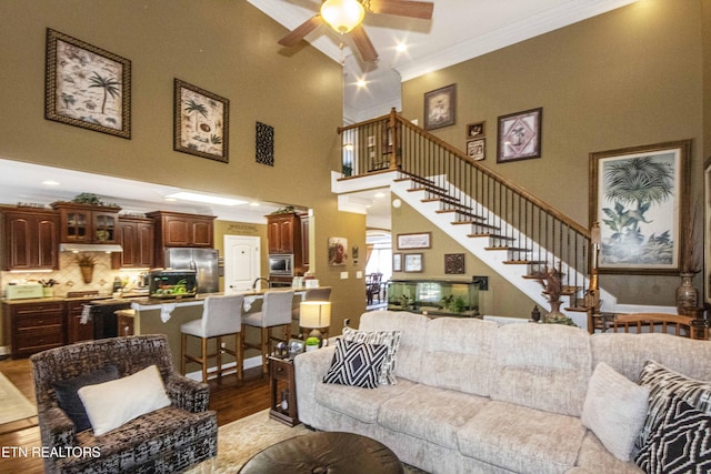8507 Cloudbreak Ln Unit 4, Knoxville, TN 37938 - living area with ornamental molding, light wood finished floors, a ceiling fan, a towering ceiling, and stairway