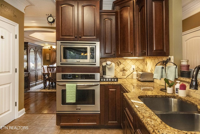 8507 Cloudbreak Ln Unit 4, Knoxville, TN 37938 - kitchen with stainless steel appliances, ornamental molding, decorative backsplash, arched walkways, and light stone counters