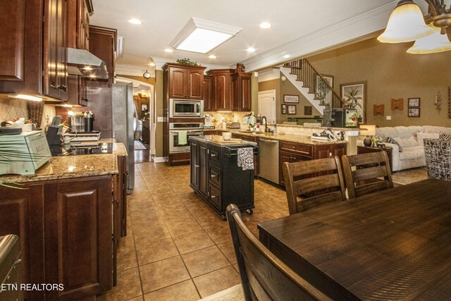 8507 Cloudbreak Ln Unit 4, Knoxville, TN 37938 - kitchen featuring appliances with stainless steel finishes, ornamental molding, range hood, light tile patterned floors, and decorative backsplash
