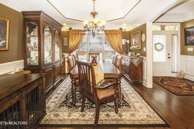 8507 Cloudbreak Ln Unit 4, Knoxville, TN 37938 - dining room featuring a chandelier, a decorative wall, a wainscoted wall, arched walkways, and dark wood-style flooring