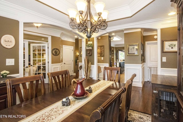 8507 Cloudbreak Ln Unit 4, Knoxville, TN 37938 - dining area featuring arched walkways, ornamental molding, a decorative wall, a chandelier, and wainscoting