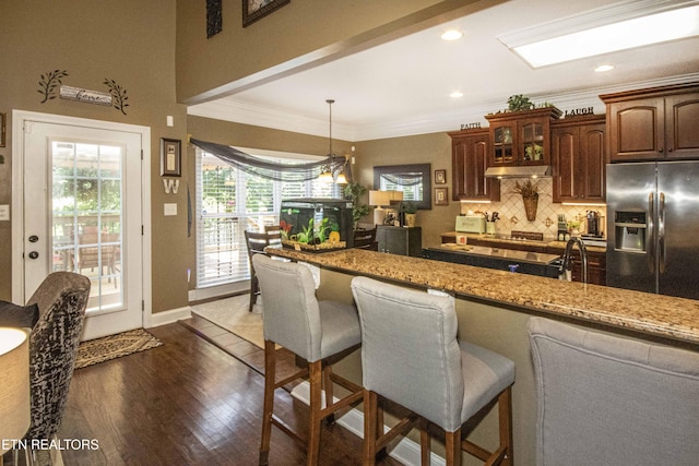 8507 Cloudbreak Ln Unit 4, Knoxville, TN 37938 - kitchen with stainless steel refrigerator with ice dispenser, backsplash, a breakfast bar area, ornamental molding, and dark wood-style flooring